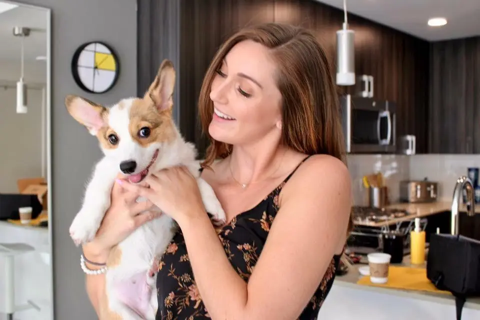 Nicole holding a corgi puppy